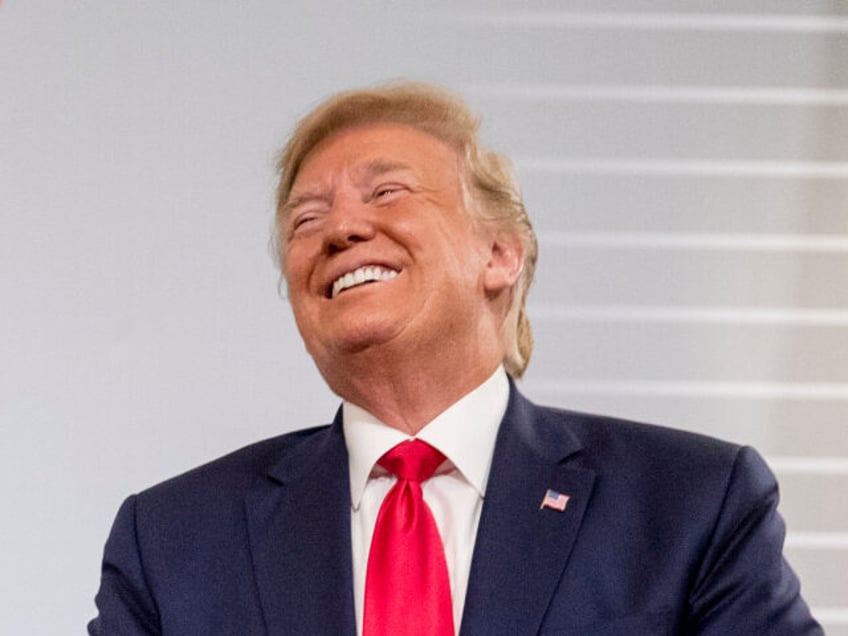 U.S. President Donald Trump and German Chancellor Angela Merkel laugh during a bilateral m