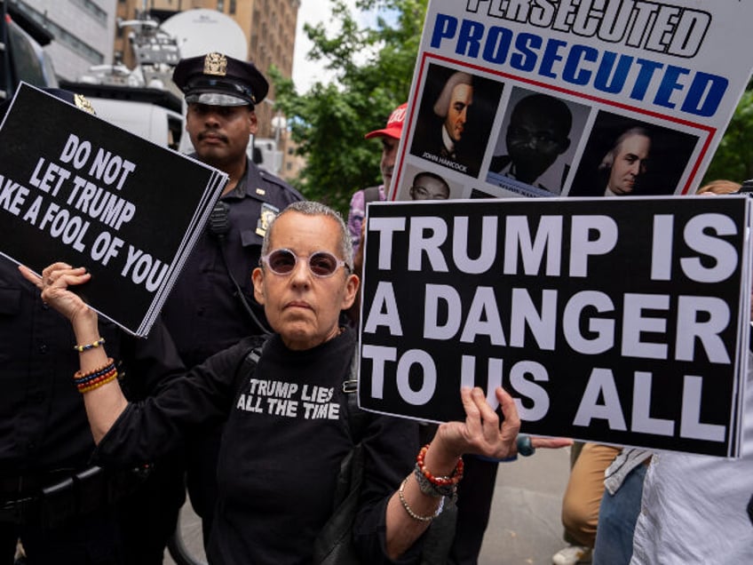 Police officers escort an anti-Trump protester from Collect Pond Park outside Manhattan Cr