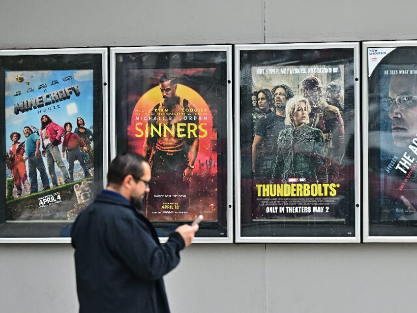 A man walks past movie posters at at AMC Theater in Montebello, California on May 5, 2025.