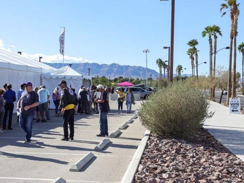 LAS VEGAS, NEVADA - OCTOBER 19: People line up to vote on the first day of in-person early