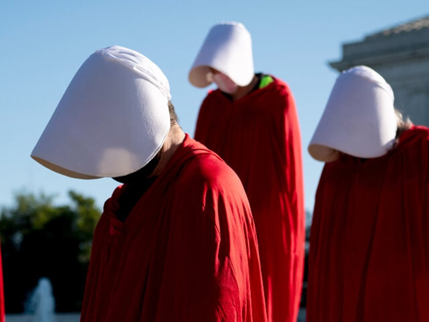 Demonstrators from the Center for Popular Democracy Action stand on the U.S. Supreme Court