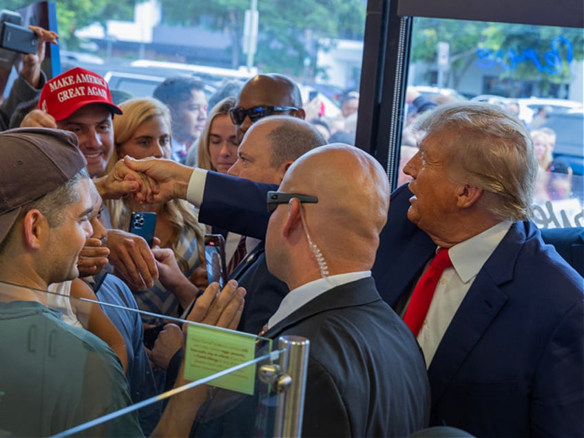 LOS ANGELES, CALIFORNIA - SEPTEMBER 29: Former U.S. President Donald Trump shakes with employees during a visit to a Carvel Ice Cream and Cake Shop during the California GOP convention on September 29, 2023 in Los Angeles, California. Presidential candidates set to speak at the convention include former President Donald Trump, Florida Gov. Ron DeSantis, South Carolina Sen. Tim Scott, and entrepreneur, Vivek Ramaswamy. The event takes place from September 29 through October 1. (Photo by David McNew/Getty Images)