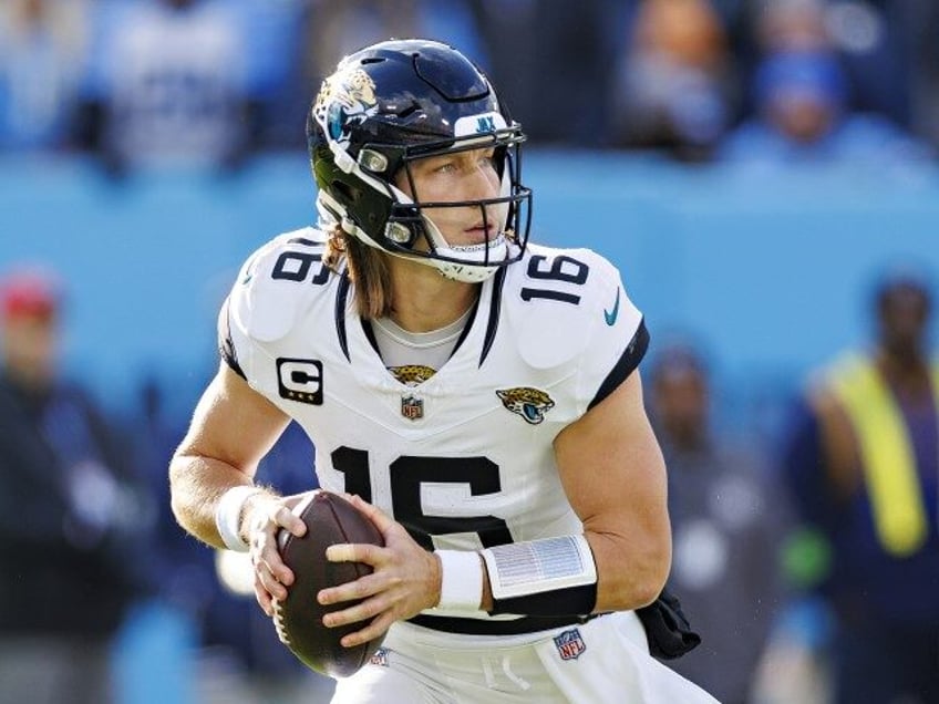 Trevor Lawrence #16 of the Jacksonville Jaguars rolls out to pass during the game against