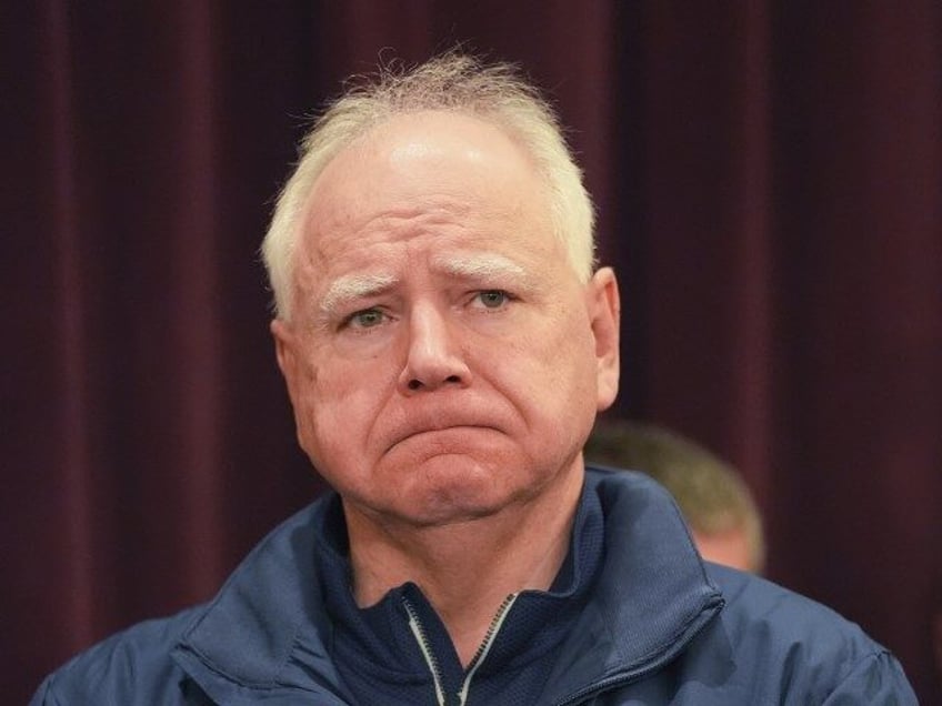 Minnesota Gov. Tim Walz stands at a press conference after two police officers and a first