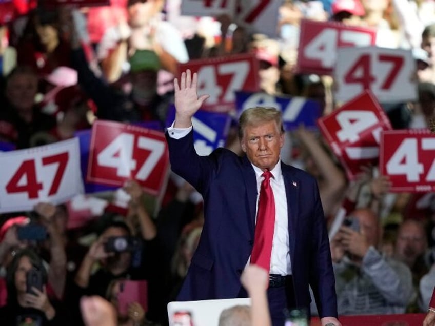 Republican presidential nominee former President Donald Trump waves during a town hall in