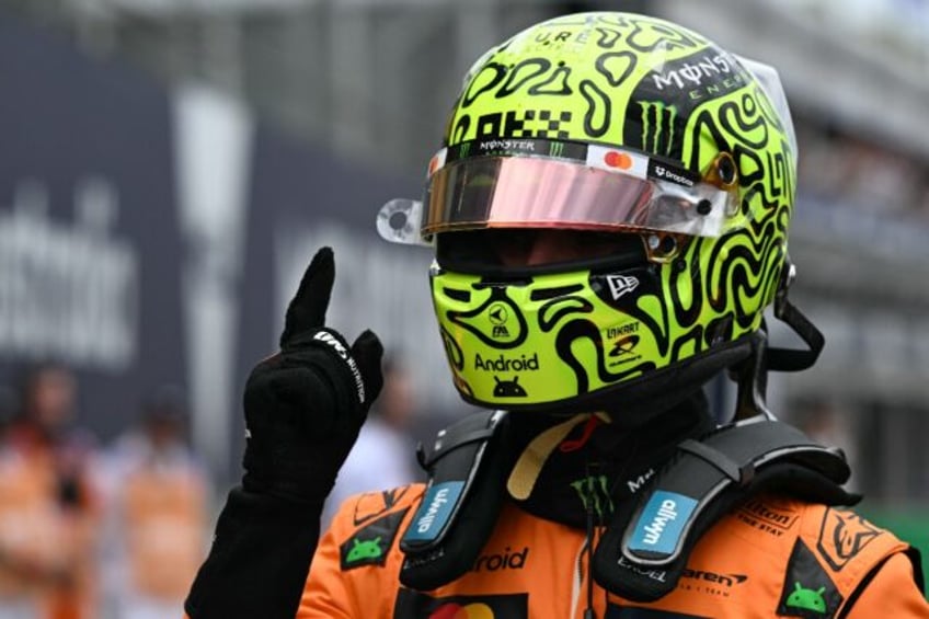 Lando Norris gives a 'number one' sign after taking pole position in Melbourne