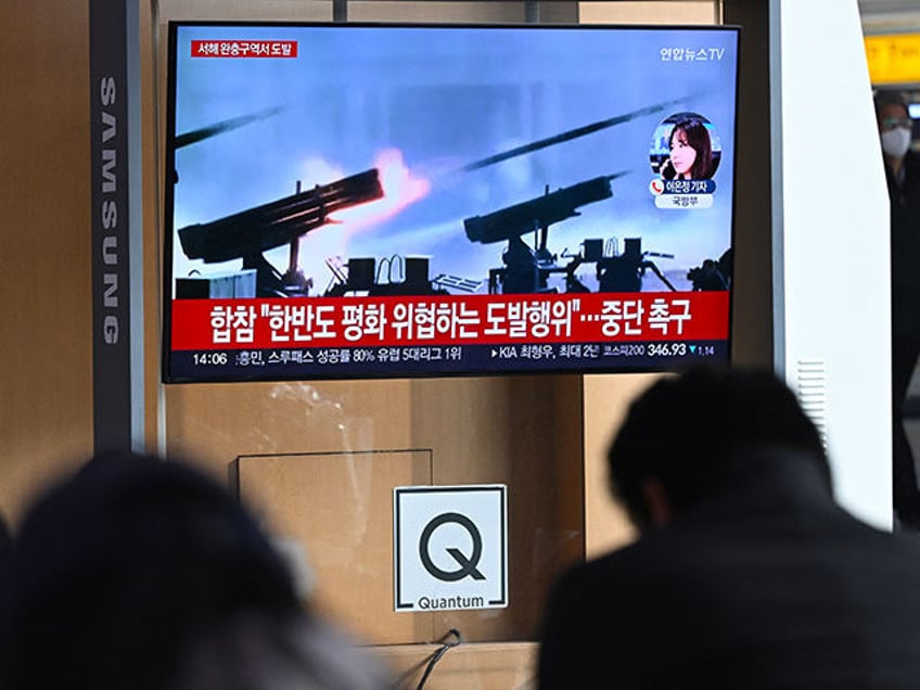 People watch a television screen showing a news broadcast with file footage of North Korea's artillery firing, at a railway station in Seoul on January 5, 2024. North Korea fired more than 200 artillery shells near two South Korean islands on January 5, Seoul's defence ministry said, with an evacuation …