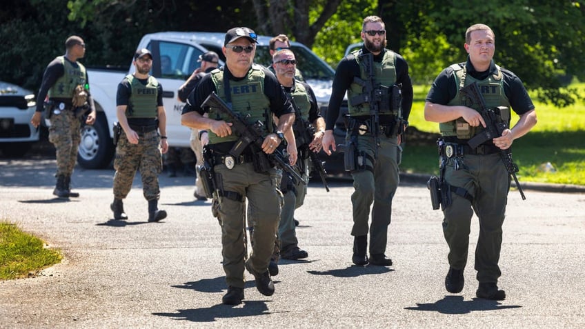 Officers with the North Carolina Prison Emergency Response Team search for escaped inmate 