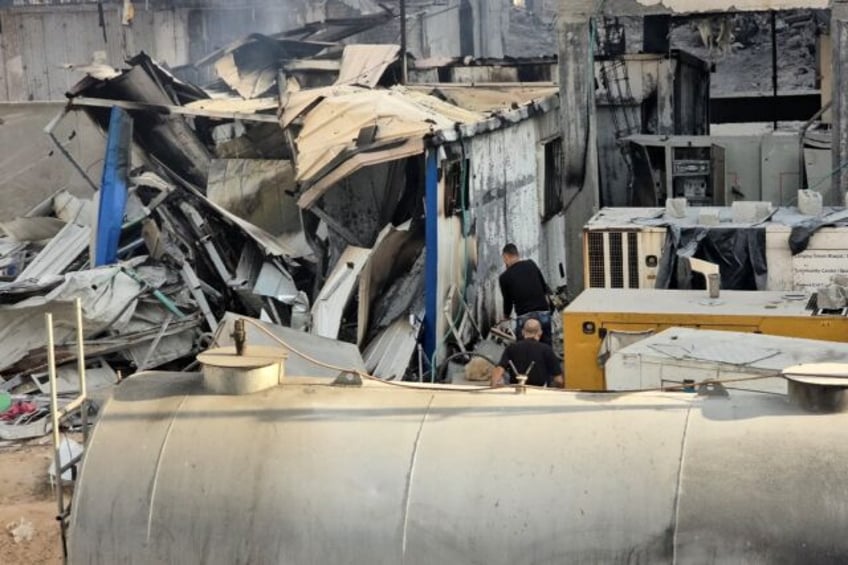 People check the damage outside the Kamal Adwan hospital in north Gaza's Beit Lahia follow