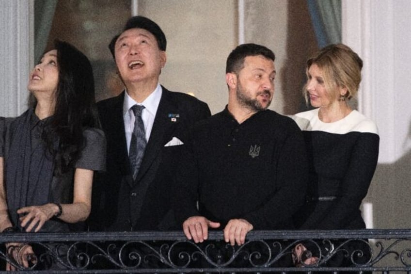 South Korean President Yoon Suk Yeol (second left) and his wife Kim Keon-hee (left) at las