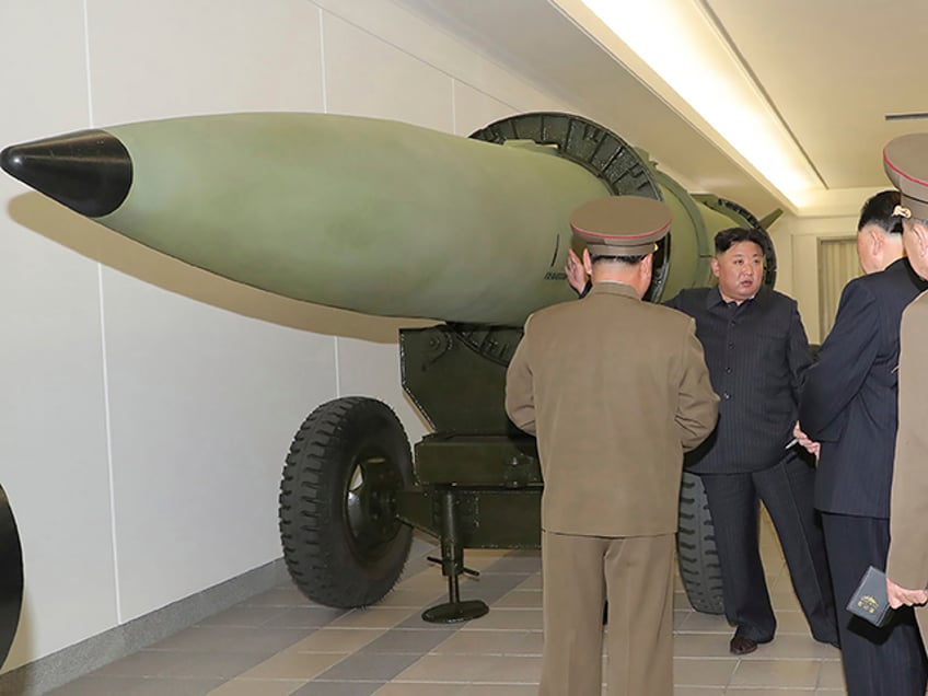 This photo provided on Tuesday, March 28, 2023, by the North Korean government, North Korean leader Kim Jong Un, rear, talks with military officials at a hall displayed what appeared to be various types of warheads designed to be mounted on missiles or rocket launchers on March 27, 2023, in undisclosed location, North Korea. Independent journalists were not given access to cover the event depicted in this image distributed by the North Korean government. The content of this image is as provided and cannot be independently verified. (Korean Central News Agency/Korea News Service via AP)