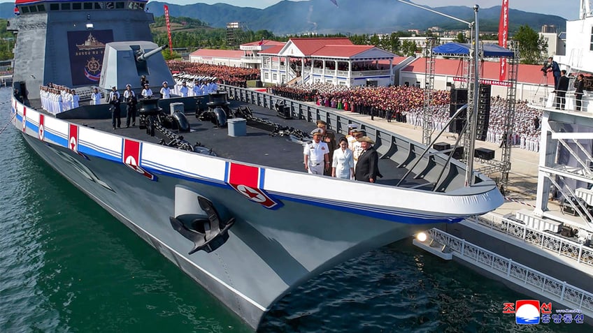 Kim Jong Un standing on the warships deck
