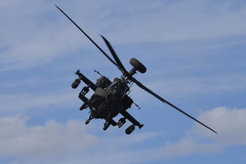 An AH-64E Apache helicopter flies during a live-fire demonstration at the Defense Expo Kor