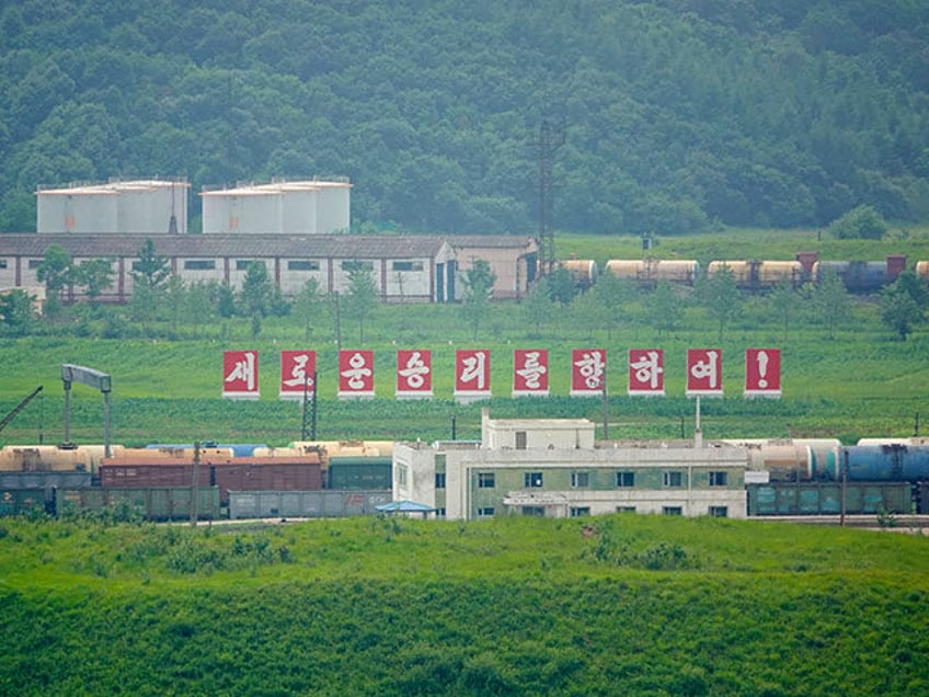 A photo is showing Russian characters on some carriages at Doumanjiang Cave railway statio