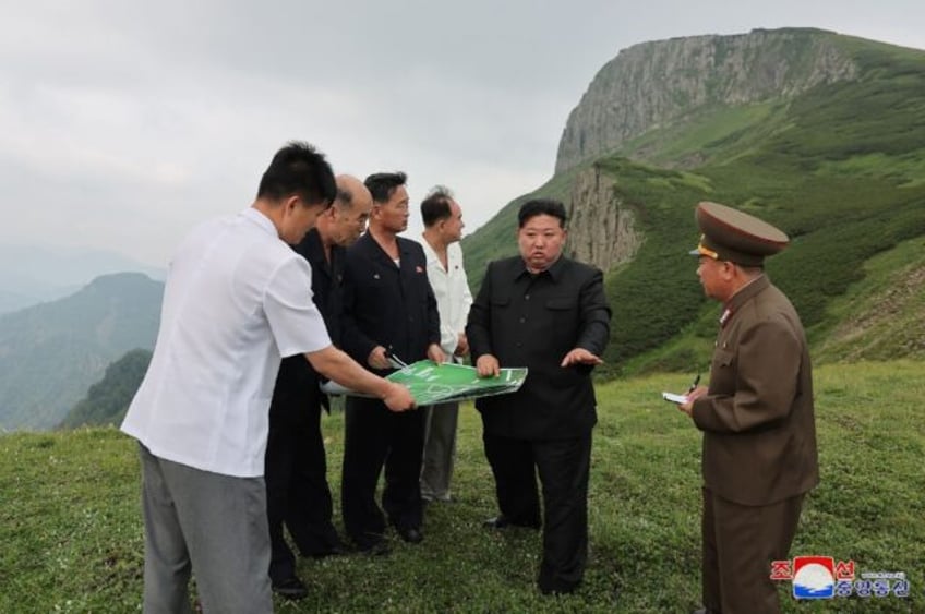 Kim Jong Un (C) has poured huge resources into developing the Samjiyon area, with the vast