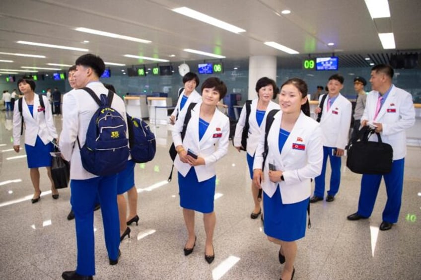 North Korean athletes posed for photos at Pyongyang airport as they prepared to take part