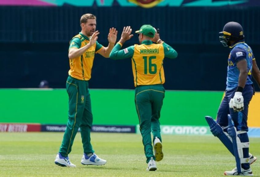 South Africa's Anrich Nortje (L) celebrates after dismissing Sri Lanka's Kamindu Mendis (R