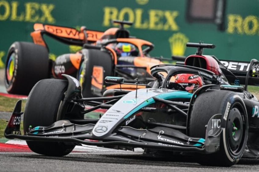 George Russell's Mercedes holds off the McLaren of Oscar Piastri during the Chinese Grand