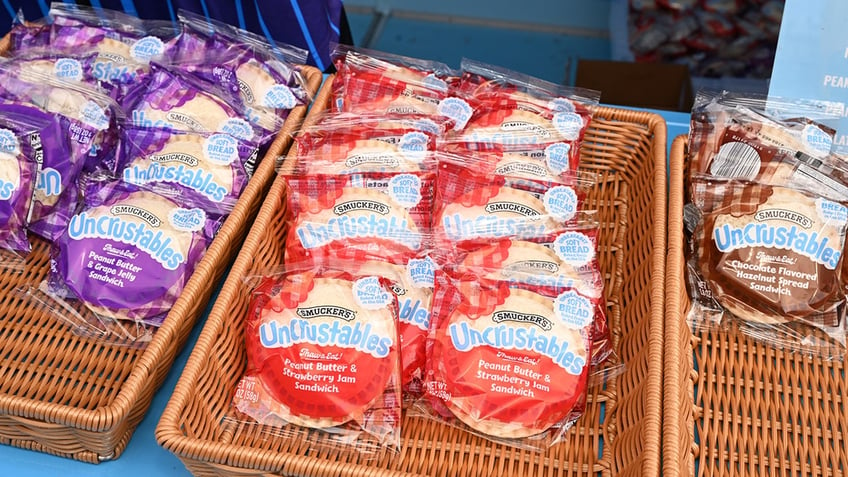 Three baskets of Uncrustables, each with a different flavor. From left to right: Grape, Strawberry, Chocolate hazelnut.