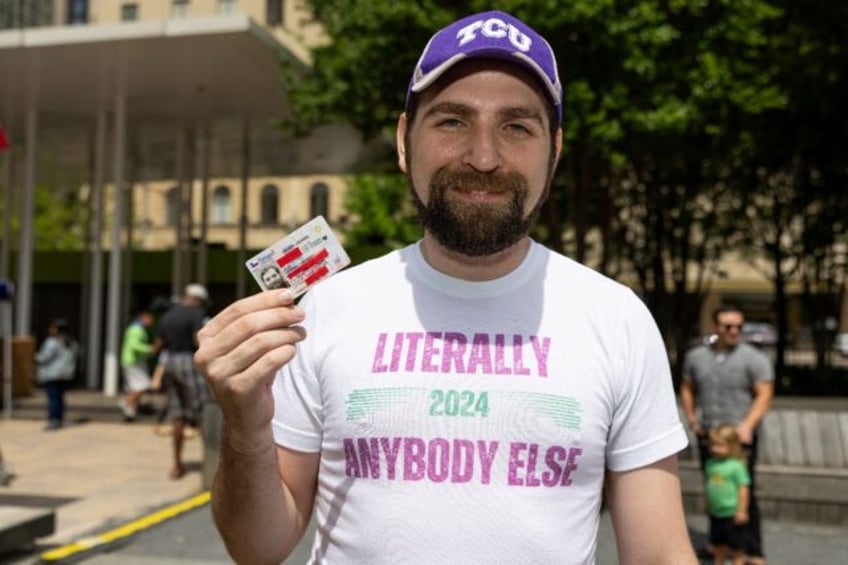 'Literally Anybody Else' poses with his driver's license, hoping for luck on his 2024 Whit