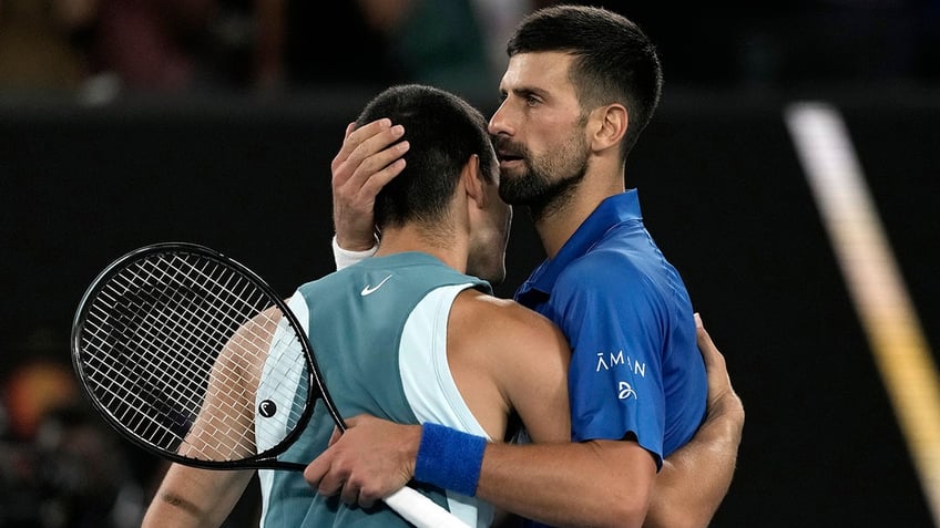 Novak Djokovic hugs Carlos Alcaraz