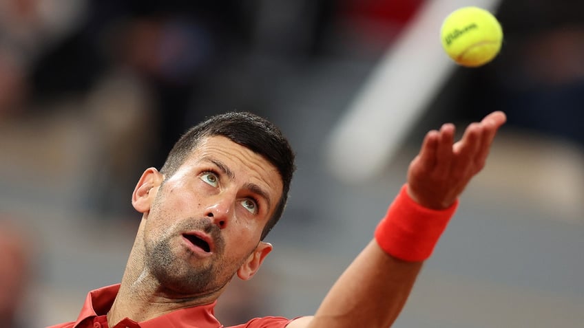 Novak Djokovic looks at the ball