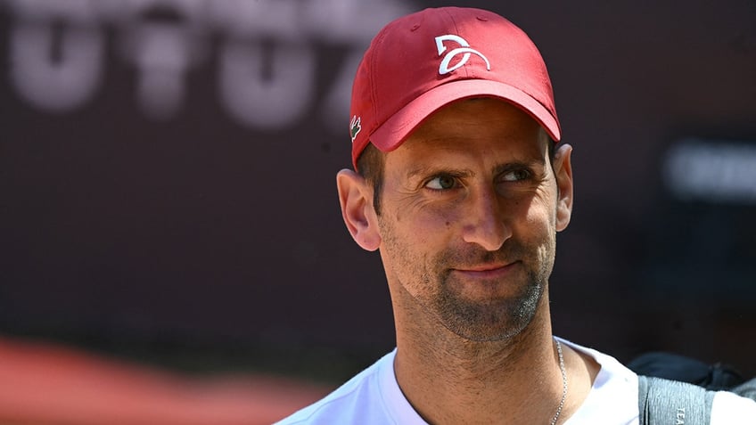 Novak Djokovic arrives at a training session