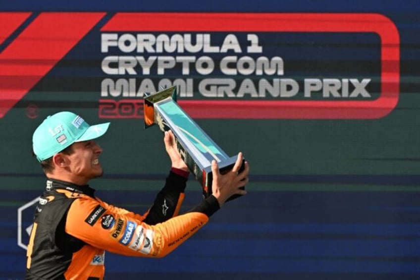 McLaren's British driver Lando Norris celebrates with his trophy after winning the Miami G