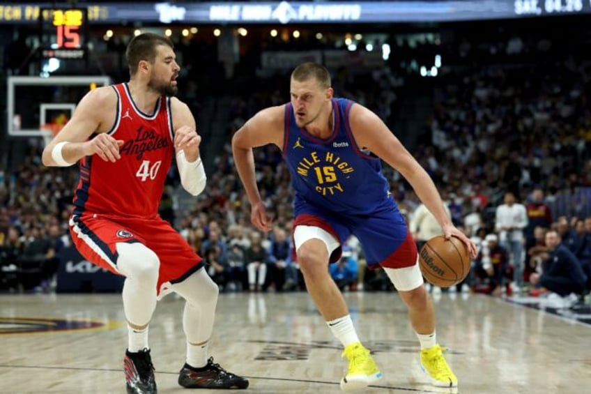 Nikola Jokic of the Denver Nuggets drives against Ivica Zubac in the Nuggets' overtime vic