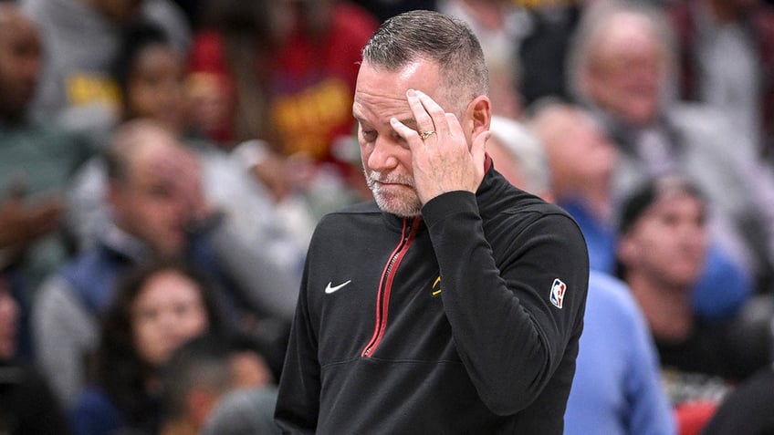 Michael Malone rubs his head