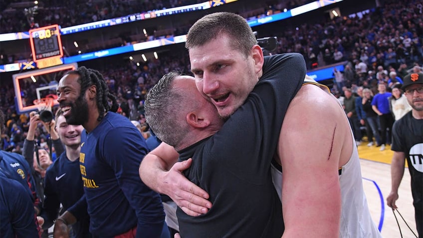 Nikola Jokic hugs Mike Malone