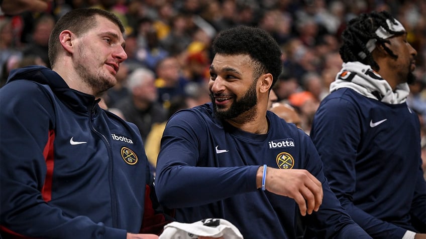 Jamal Murray and Nikola Jokic talk on the bench