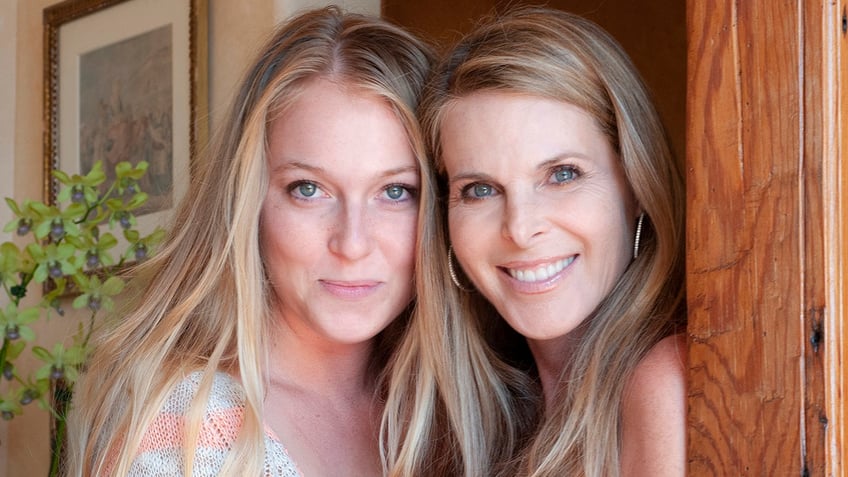 India Oxenberg and her mother looking directly at the camera and smiling