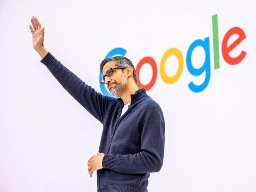 Sundar Pichai of Google waves to his paid supporters