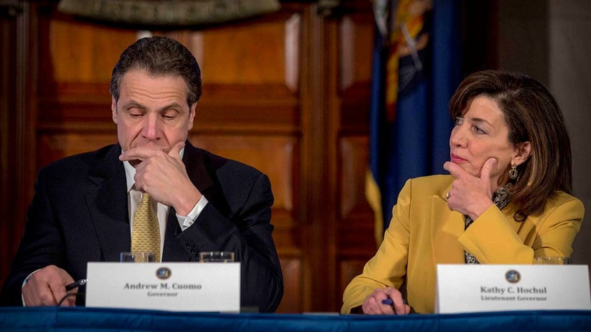 Kathy Hochul, right, looking at then-Gov. Andrew Cuomo, left