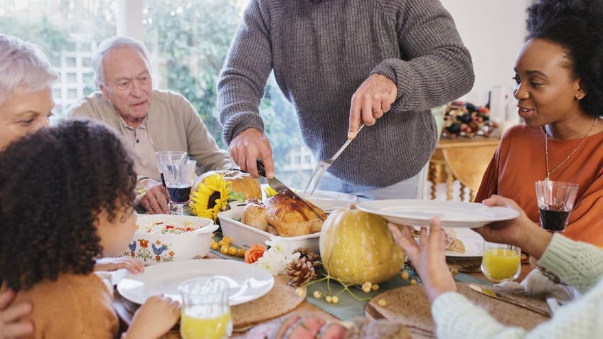 Holiday diners wait while turkey gets carved