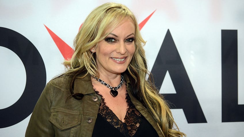 Stormy Daniels smiling at an adult film expo