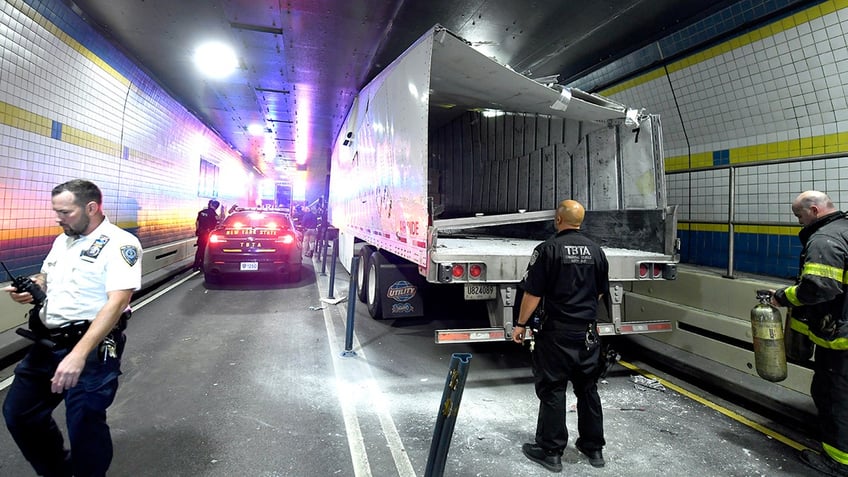 nyc firefighters seen cutting apart truck that got wedged in tunnel causing traffic nightmare