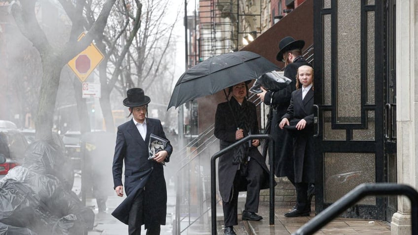 Men arrive to a Orthodox Synagogue in Brooklyn on December 30, 2019 in New York City, two days after an intruder wounded five people at a rabbis house in Monsey, New York during a gathering to celebrate the Jewish festival of Hanukkah.