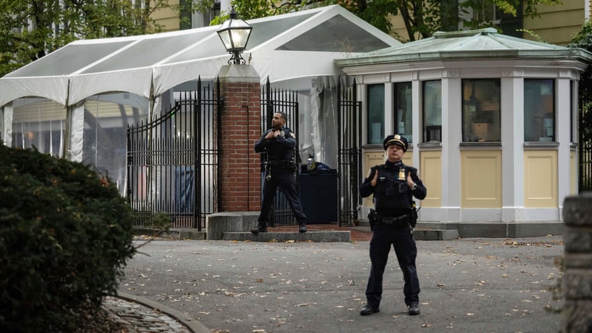 A NYPD officer stands outside Gracie Mansion