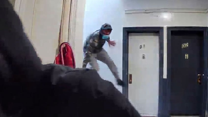 Masked man jumps over railing on ring doorbell video