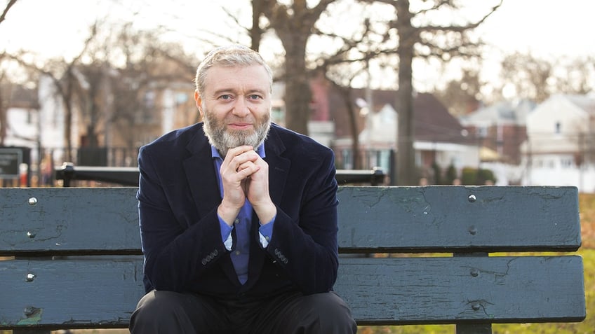 Prof. Avraham Goldstein sitting on park bench