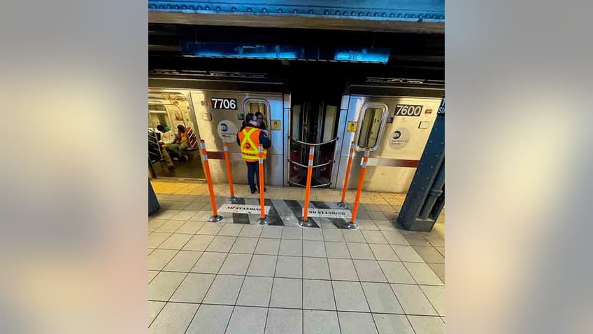 rubber poles around no standing zone on subway platform