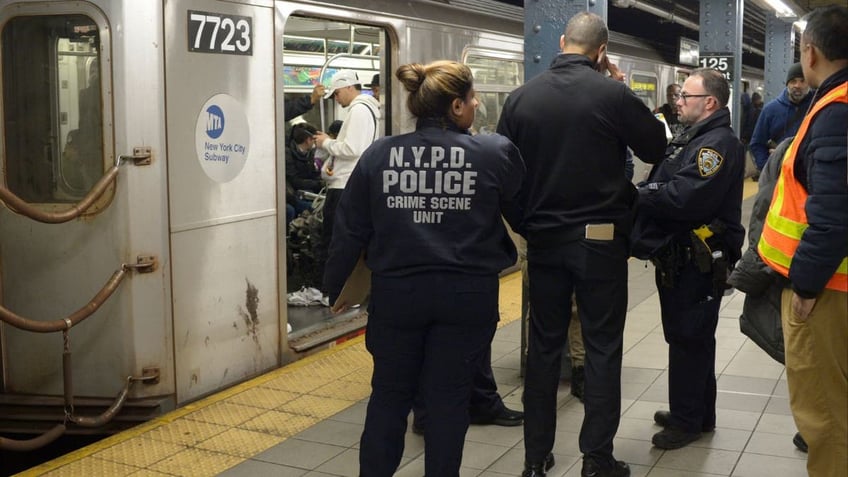 Police at a train station after a man was fatally killed