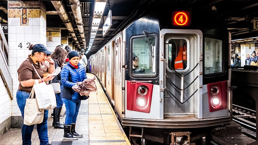 nyc woman shoved into moving subway train is fighting for her life officials say