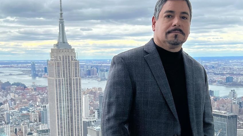 James Caban in front of the NYC skyline