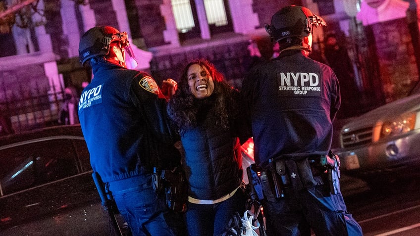 Officers arresting a protester