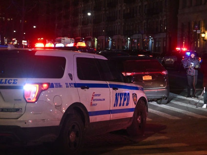 Police officers lock down the scene after two NYPD officers were shot in Harlem on January 21, 2022 in New York City. (Photo by Alexi Rosenfeld/Getty Images)