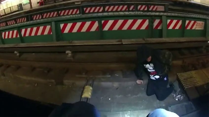 nypd officers save straphanger who fell onto subway tracks in queens