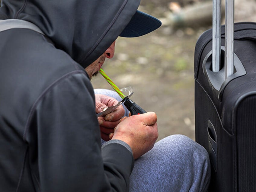 A homeless man, 24, smokes fentanyl on March 12, 2022 in Seattle, Washington. Widespread d